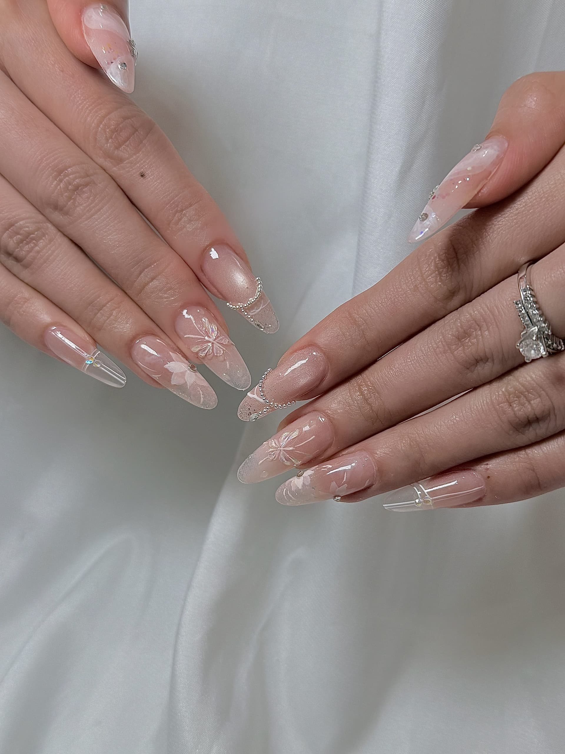 Bridal floral nail art with delicate crystal accents